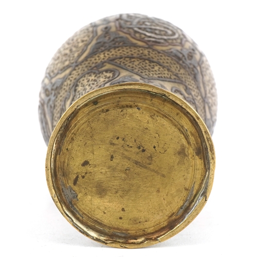 1534 - A Middle Eastern brass baluster vase with silver and copper inlay, profusely engraved with scrolling... 