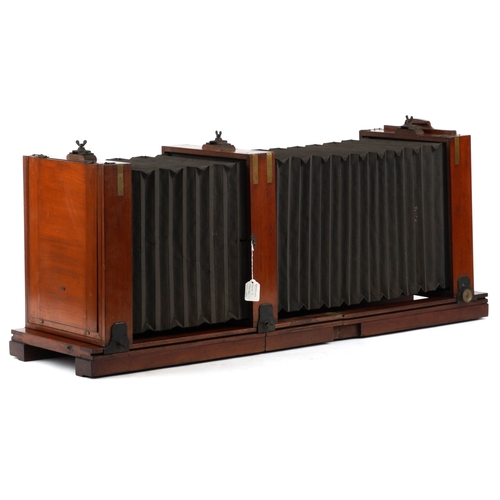  A large 19th century brass bound mahogany double bellow plate field camera, 112cm in length.