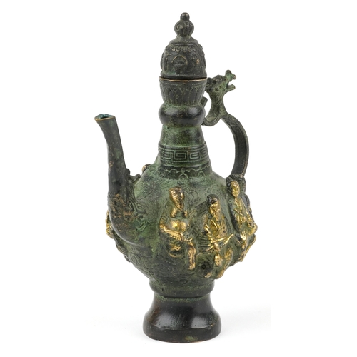 456 - A Chinese patinated brass wine jug with animalia handle, cast in high relief with elders, character ... 