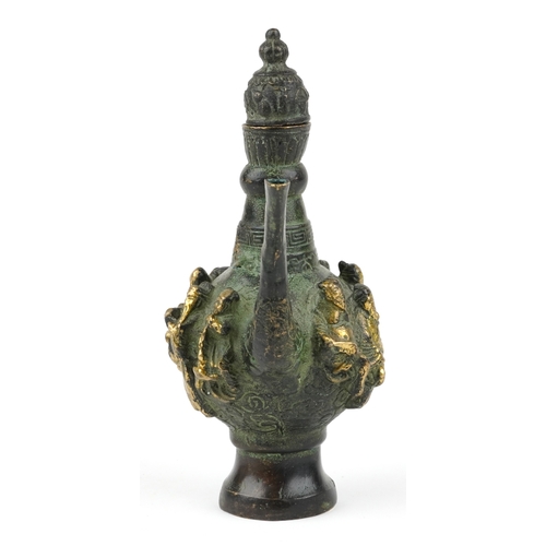 456 - A Chinese patinated brass wine jug with animalia handle, cast in high relief with elders, character ... 