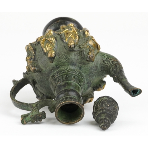 456 - A Chinese patinated brass wine jug with animalia handle, cast in high relief with elders, character ... 