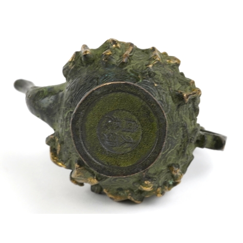 456 - A Chinese patinated brass wine jug with animalia handle, cast in high relief with elders, character ... 