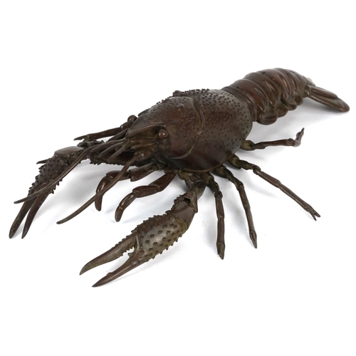 565 - A Japanese patinated bronze crayfish with articulate limbs, 26cm in length.