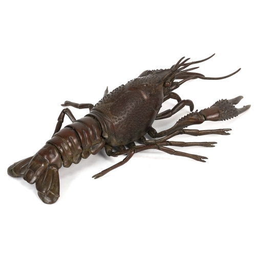 565 - A Japanese patinated bronze crayfish with articulate limbs, 26cm in length.