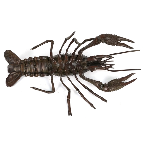 565 - A Japanese patinated bronze crayfish with articulate limbs, 26cm in length.