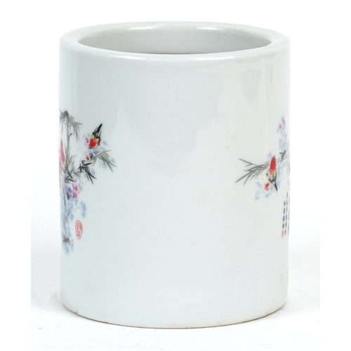 1694 - A Chinese porcelain brush pot decorated with birds in trees, 12cm high.