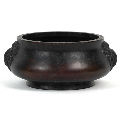 1693 - A Chinese patinated bronze censer with dragon head handles, 7cm high x 14cm in diameter