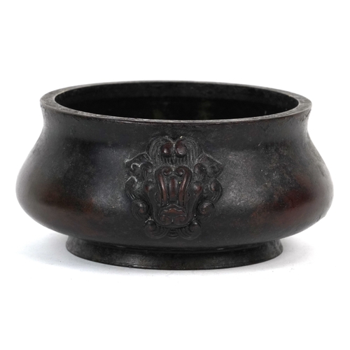 1693 - A Chinese patinated bronze censer with dragon head handles, 7cm high x 14cm in diameter