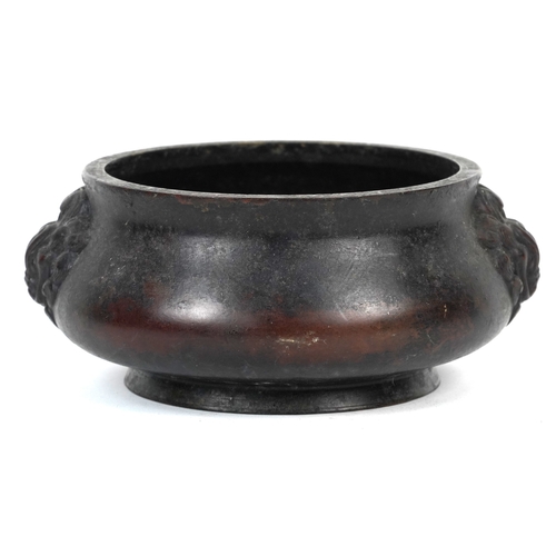 1693 - A Chinese patinated bronze censer with dragon head handles, 7cm high x 14cm in diameter