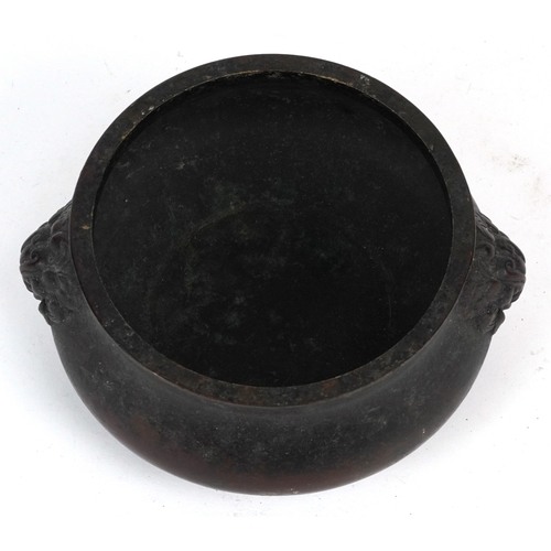 1693 - A Chinese patinated bronze censer with dragon head handles, 7cm high x 14cm in diameter