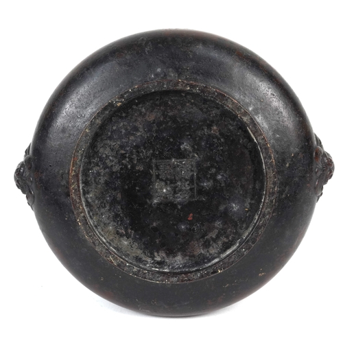 1693 - A Chinese patinated bronze censer with dragon head handles, 7cm high x 14cm in diameter