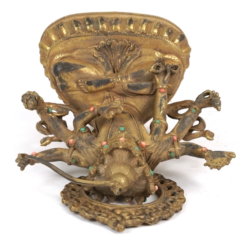 151 - A Chino Tibetan patinated bronze figure of a seated Buddha with pink and green coloured birds, 22cm ... 