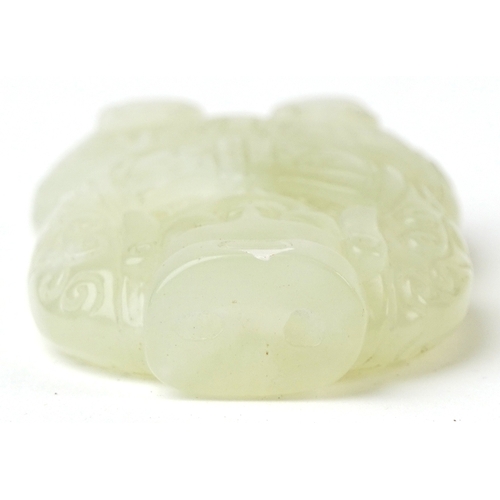 508 - A Chinese green stone carving of a kneeling figure, 6cm high, 58.7g.