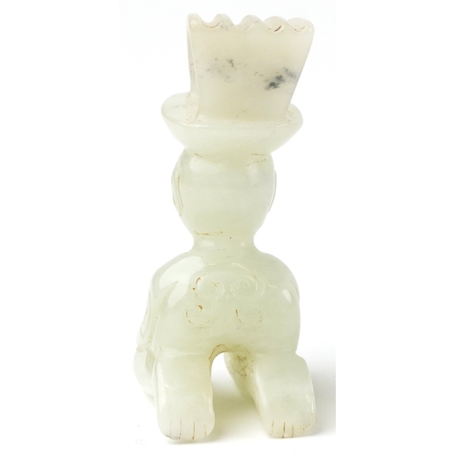 149 - A Chinese green stone carving of a seated figure, 7cm high.