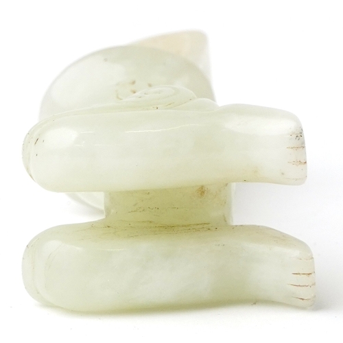 149 - A Chinese green stone carving of a seated figure, 7cm high.