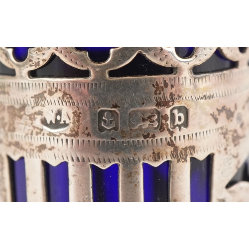 3655 - William Adams, a pair of Victorian silver casters having pierced friezes and blue glass liners, Birm... 