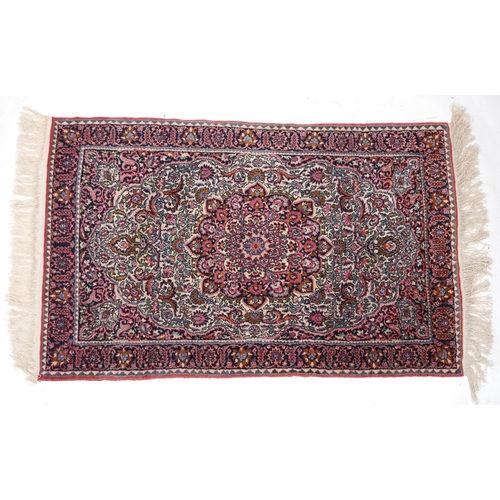 2219 - A Turkish rug, late 20th century, the pink field with a central stylized medallion within a compleme... 