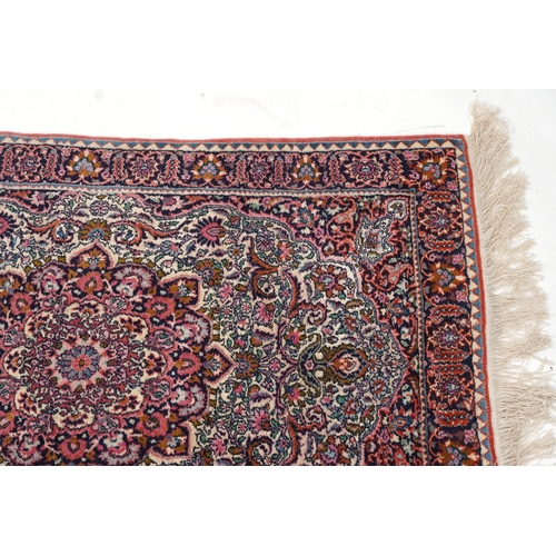 2219 - A Turkish rug, late 20th century, the pink field with a central stylized medallion within a compleme... 