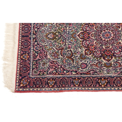 2219 - A Turkish rug, late 20th century, the pink field with a central stylized medallion within a compleme... 