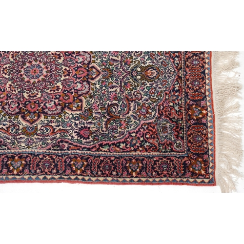 2219 - A Turkish rug, late 20th century, the pink field with a central stylized medallion within a compleme... 