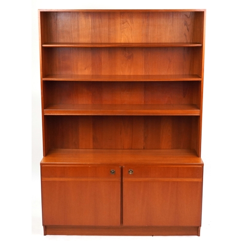 2007 - A mid 20th century teak bookcase cabinet by McIntosh, the open shelves above a pair of cupboards, on... 