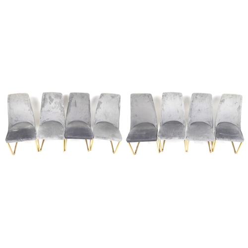 2125 - A set of eight modern dining chairs upholstered in grey suede, raised on gilt metal cantilever bases... 