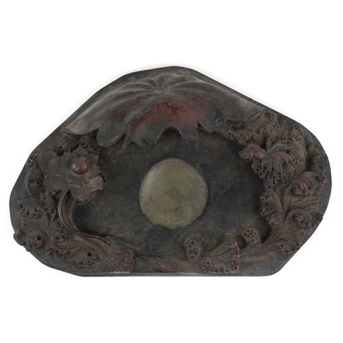 512 - A Chinese scholar's inkstone carved with a fish amongst waves, 49cm wide.