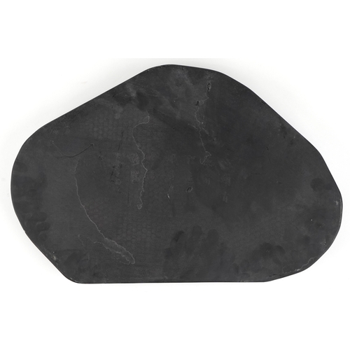 512 - A Chinese scholar's inkstone carved with a fish amongst waves, 49cm wide.