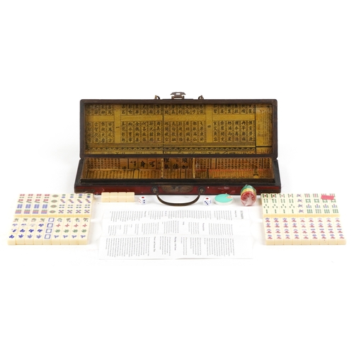 561 - A 20th century Chinese Mahjong set housed in a fitted case, 43.5cm wide.