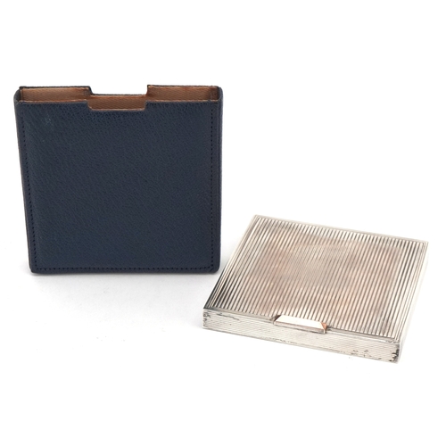 38 - David Sutton & Sons, an Art Deco style engine turned silver compact, London circa 1946-1951, 7.5cm x... 