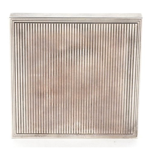 38 - David Sutton & Sons, an Art Deco style engine turned silver compact, London circa 1946-1951, 7.5cm x... 