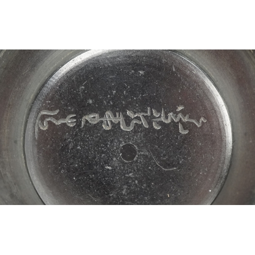  A Japanese cast iron teapot, 19th century, decorated with a phoenix bearing a nine character mark to... 