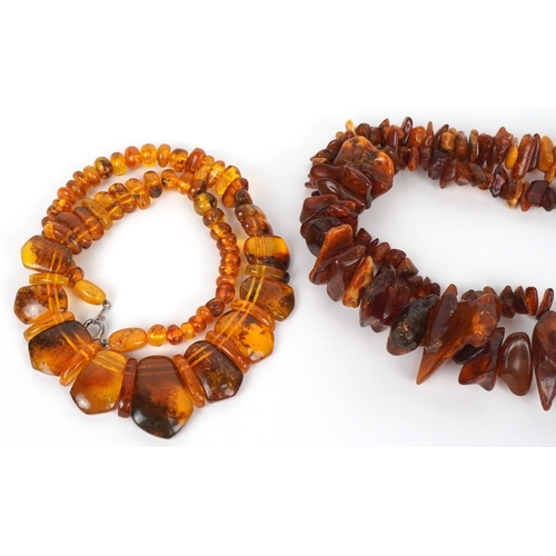 3518 - Two amber coloured bead necklaces together with a similar pendant on a white metal necklace, the lar... 