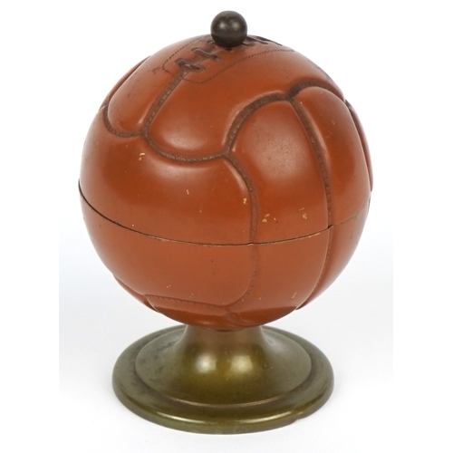 A football interest novelty table lighter in the form of a football engraved Winners Divs I IV.VI.BL 1957/58 R Whittington W.H.F.C, 8cm high.