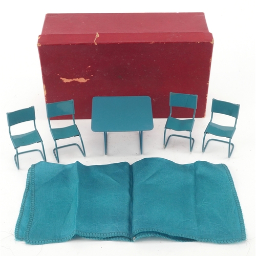 727 - Metal doll's house furniture comprising a table and four chairs, the table 4.5cm high.