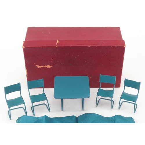 727 - Metal doll's house furniture comprising a table and four chairs, the table 4.5cm high.