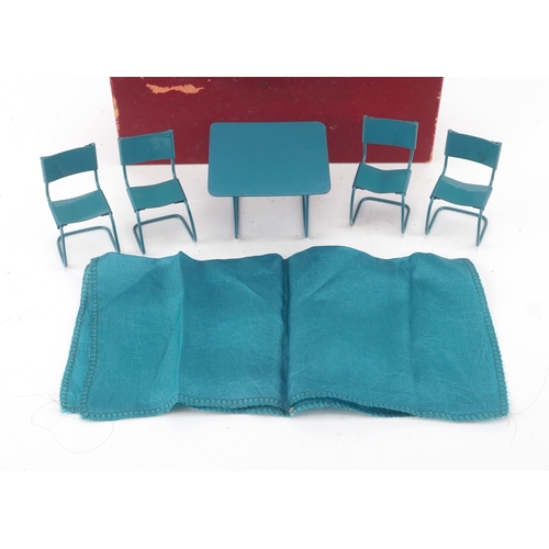 727 - Metal doll's house furniture comprising a table and four chairs, the table 4.5cm high.