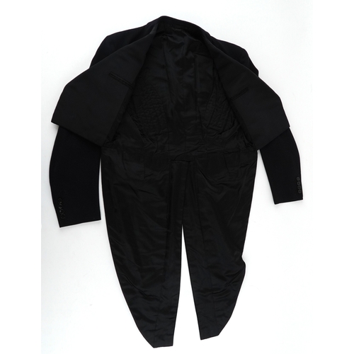 1033 - A collection of theatre costumes including a boned petticoat skirt, a tail coat, ladies dresses and ... 