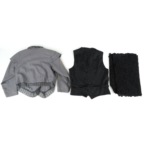 1033 - A collection of theatre costumes including a boned petticoat skirt, a tail coat, ladies dresses and ... 