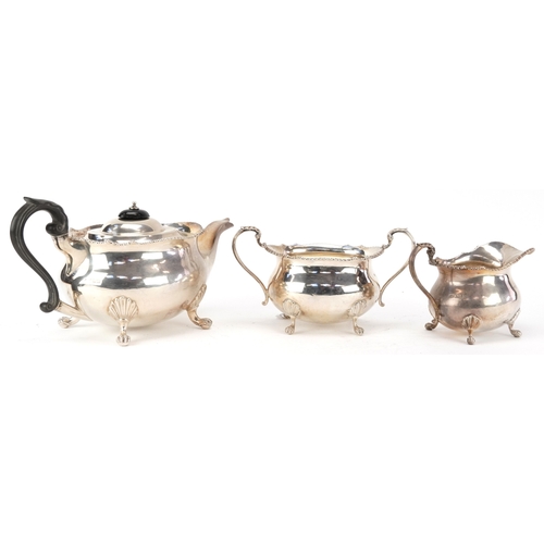 24 - Mappin & Webb, a George V silver three piece tea service raised on ball and claw feet, Sheffield 191... 
