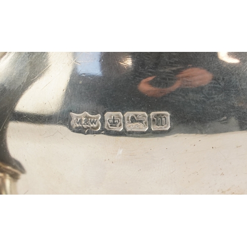 24 - Mappin & Webb, a George V silver three piece tea service raised on ball and claw feet, Sheffield 191... 