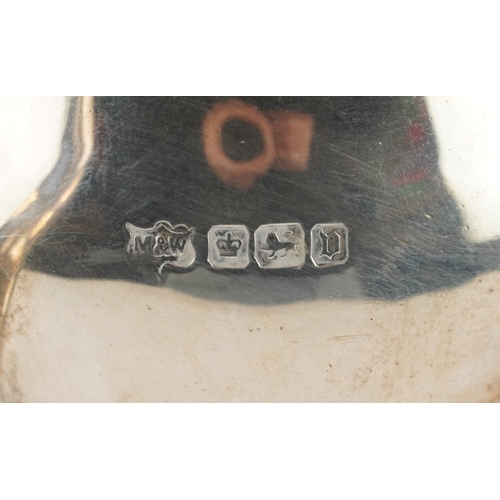 24 - Mappin & Webb, a George V silver three piece tea service raised on ball and claw feet, Sheffield 191... 