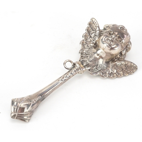 43 - A silver babies rattle in the form of a cherub, London import mark 1994, 12cm in length, 29.1g.