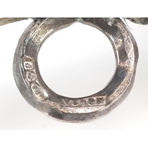 43 - A silver babies rattle in the form of a cherub, London import mark 1994, 12cm in length, 29.1g.