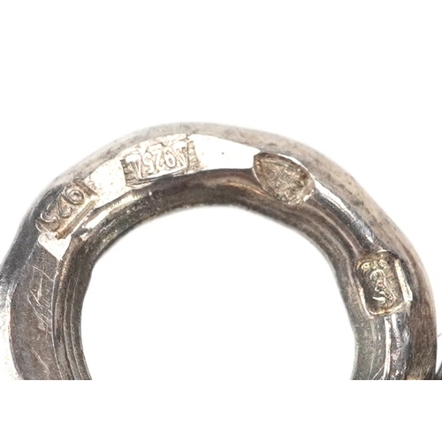 43 - A silver babies rattle in the form of a cherub, London import mark 1994, 12cm in length, 29.1g.