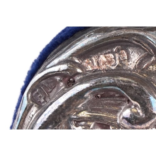 39 - Henry Matthews, a very large silver easel photo frame profusely embossed with flowers, foliage and a... 