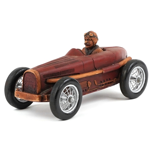 1852 - A Modern resin model of a single seater racing car finished in red, with spoke wheels, 52cm in lengt... 