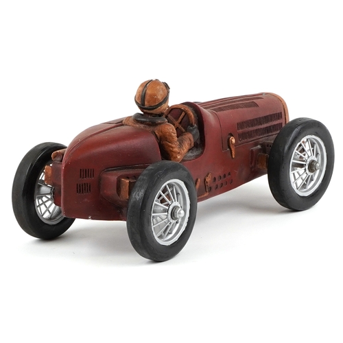 1852 - A Modern resin model of a single seater racing car finished in red, with spoke wheels, 52cm in lengt... 