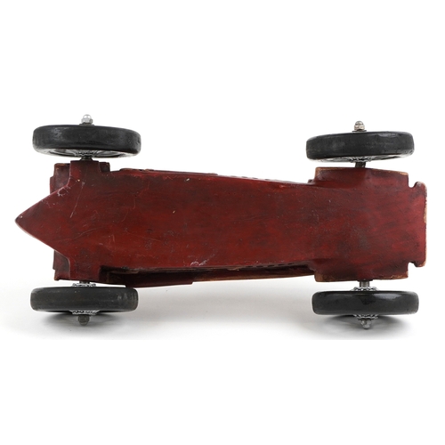 1852 - A Modern resin model of a single seater racing car finished in red, with spoke wheels, 52cm in lengt... 