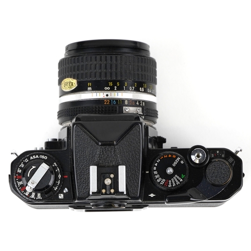 1051 - A Nikon FE2 camera with lens and a 75-150 lens